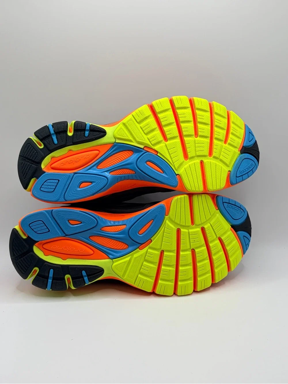 Saucony navy running shoes with orange & neon yellow accents